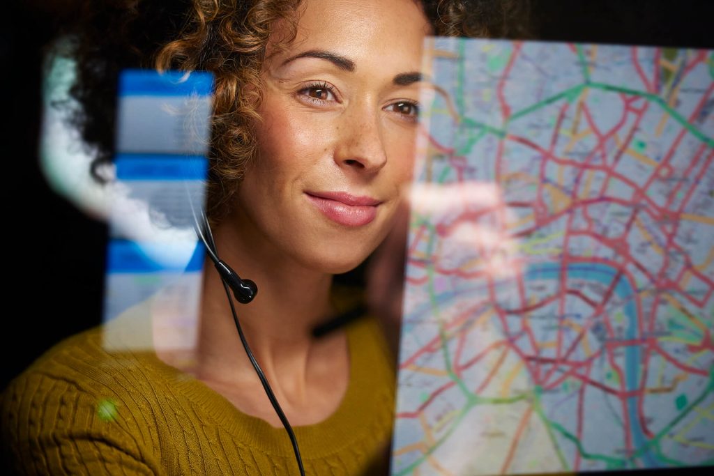 Woman with headset looking at report